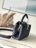 CAPUCINES EAST-WEST 33 IN BLACK CALFSKIN GOLD HARDWARE